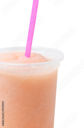 Close up of fruit juice in plastic glass.