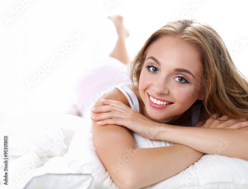 Beautiful young women lying on bed