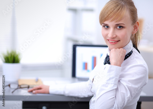 Portrait of  businesswoman sitting at  desk with a laptop © shefkate