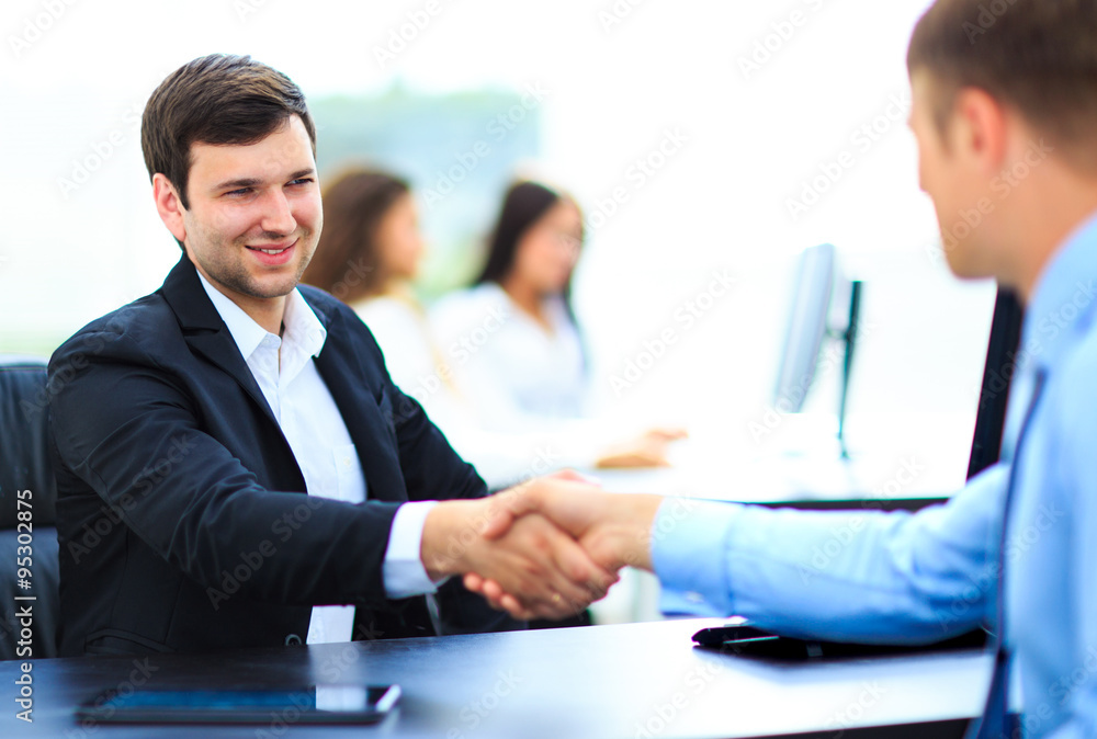 Business people shaking hands, finishing up a meeting Business people shaking hands, finishing up a meeting
