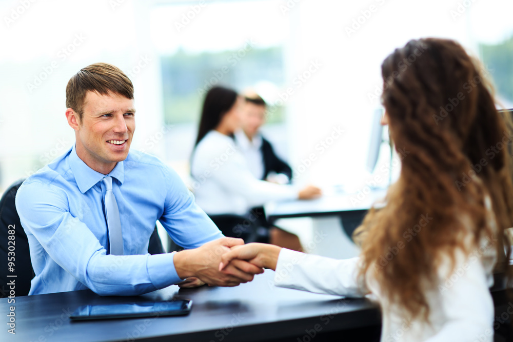 Salesman shaking hands to clients Salesman shaking hands to clients