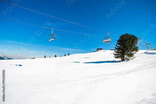 Cable ski lift chairs against blue sky in Austrian Alps, Mayrhofen ski resort