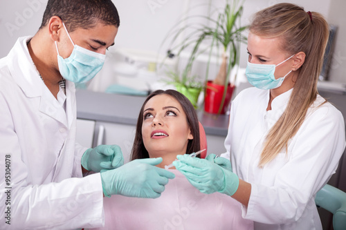 Dentist assistant preparing a syringe anesthetize