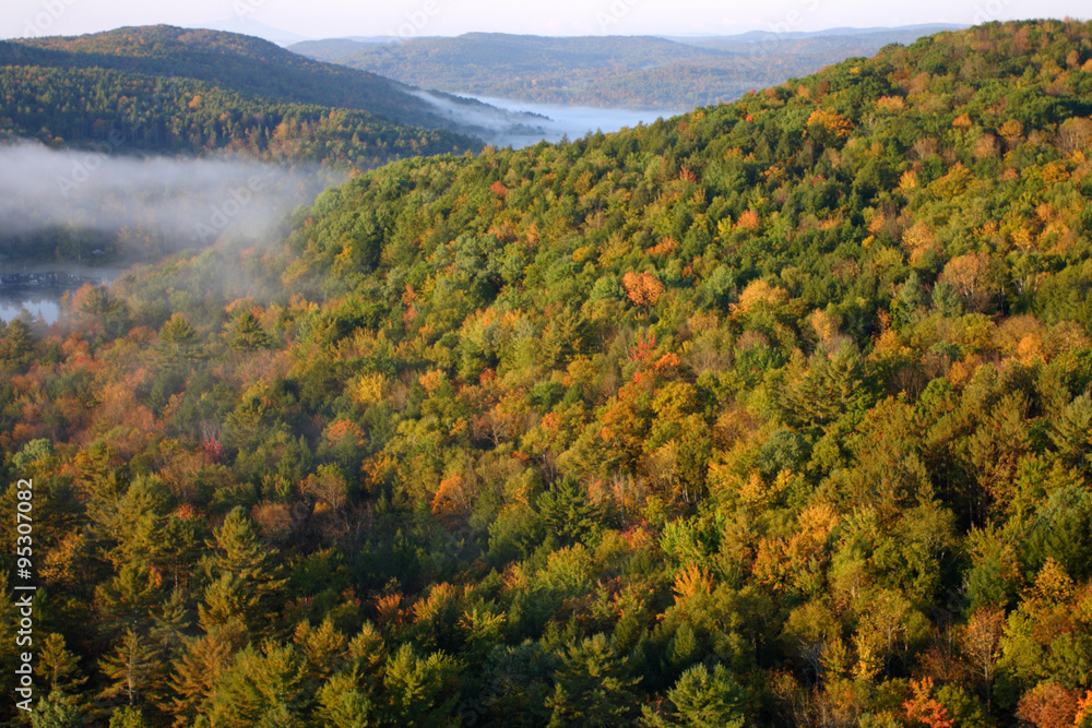 An aerial view of a hot air balloon floating over the Vermont country side ..