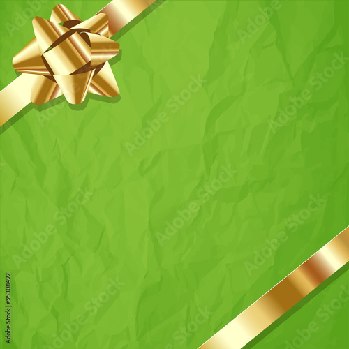 Gold ribbon on a crumpled paper green background.