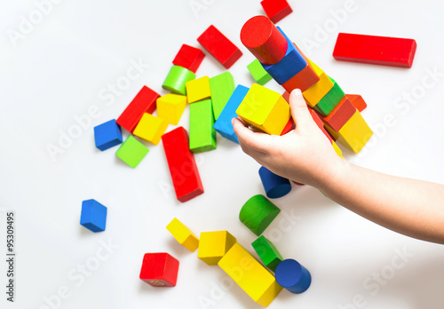 Children playing multicolor toy blocks