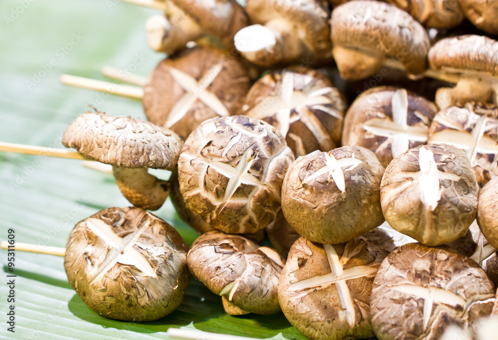 Shiitake mushroom with skewers on banana leaf. Shiitake mushroom with skewers on banana leaf.