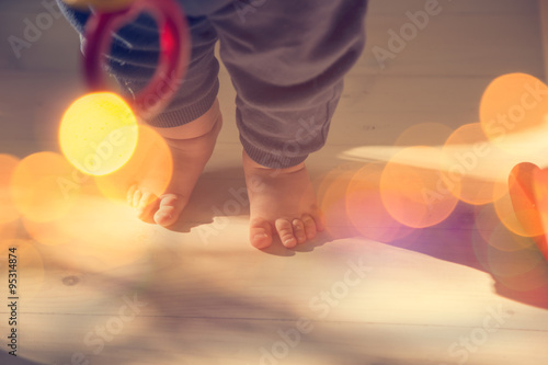 Small Baby Feet on Wooden Floor © Maryia Bahutskaya