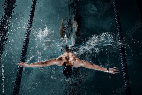 Sportsman swims in a swimming pool photo