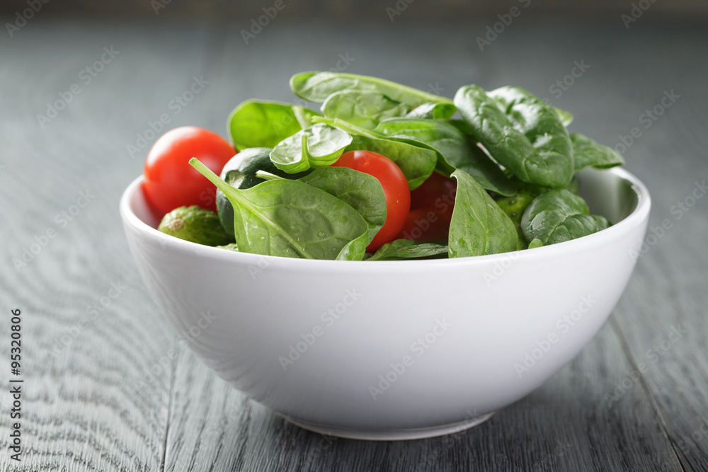 tomatoes and cucumbers in bowl on wood table tomatoes and cucumbers in bowl on wood table