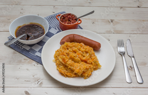 Hutspot with smoked sausage on a white plate photo