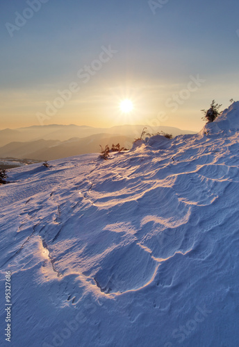 Landscape with sun and winter mountain