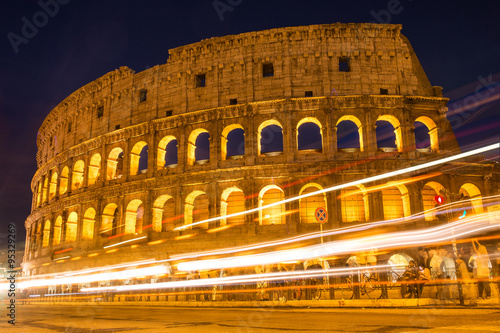 Colosseum at night with colorful blurred traffic lights. Rome -