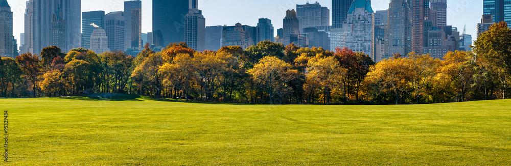 Morning panoramic view of Sheep Meadow and Central Park South skyscrapers with Fall foliage. Manhattan, New York City