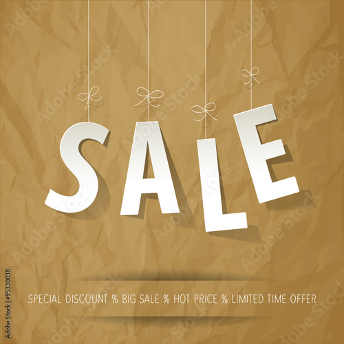 SALE paper letters white on a crumpled paper brown background.