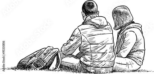 young pair has a rest on a grass