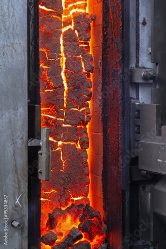 View of the finished coke into the open door of the coke oven