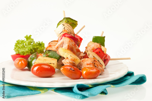 Fried barbeque meat on a bamboo sticks with vegetables