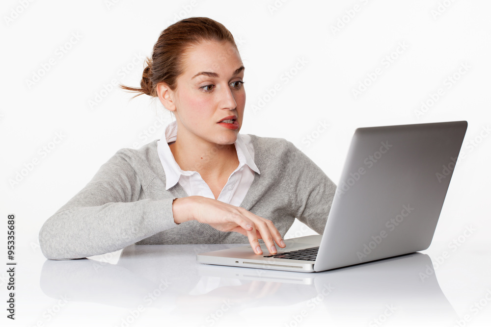 worried 20s female student writing on laptop in white office worried 20s female student writing on laptop in white office