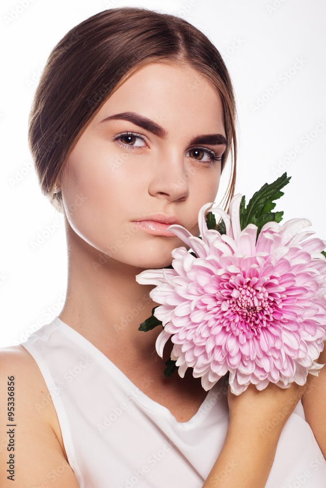 Beautiful girl with pink flower near face