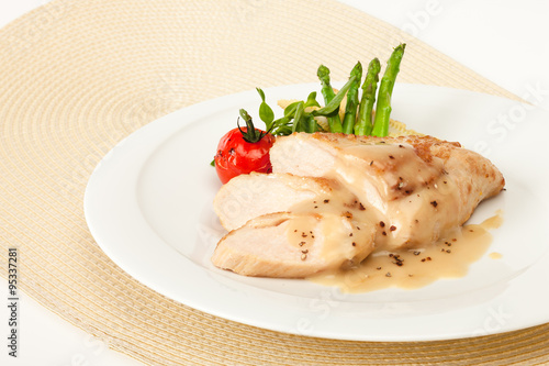 Fried chicken fillet in white cream sauce