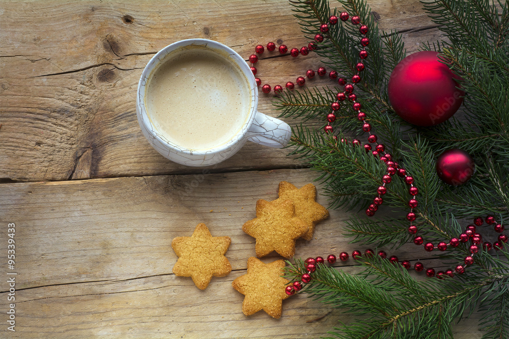 Cup of coffee with cookies in star shape and fir branches with c Cup of coffee with cookies in star shape and fir branches with c