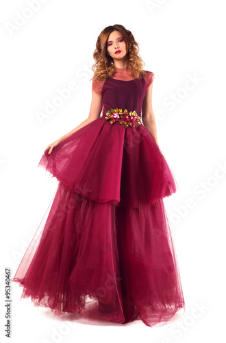 Young beautiful woman model in fairy red marsala dress. Isolated on white background.