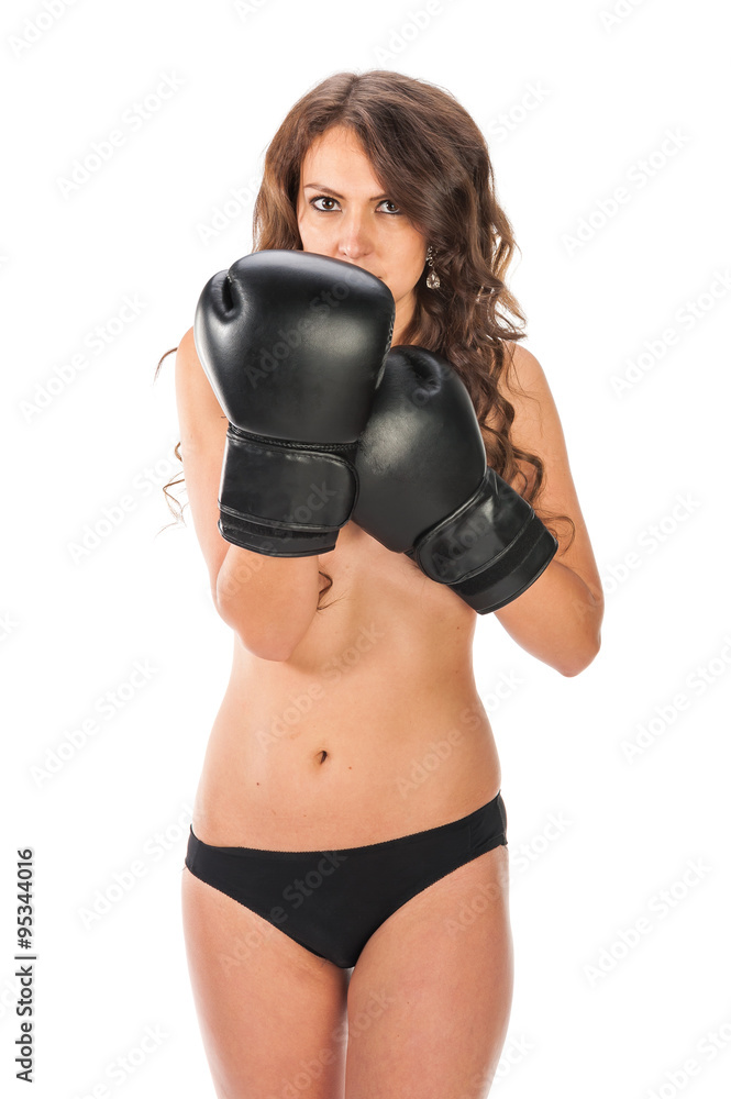 Boxer young girl poses in the studio with boxing gloves Boxer young girl poses in the studio with boxing gloves