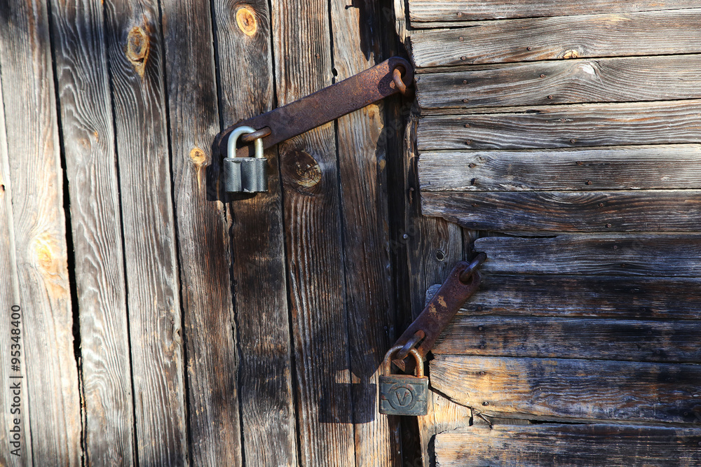 lock on old wooden door lock on old wooden door