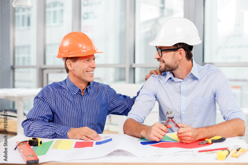 Cheerful male engineers are discussing the construction Cheerful male engineers are discussing the construction