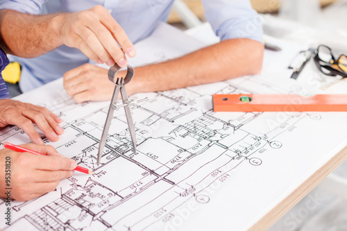Experienced male architects are working at project
