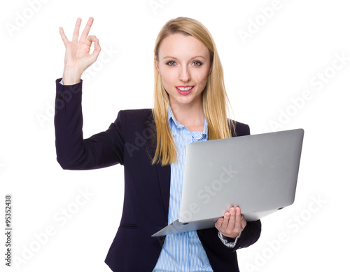 Young Businesswoman hold with laptop computer and ok sign gestur