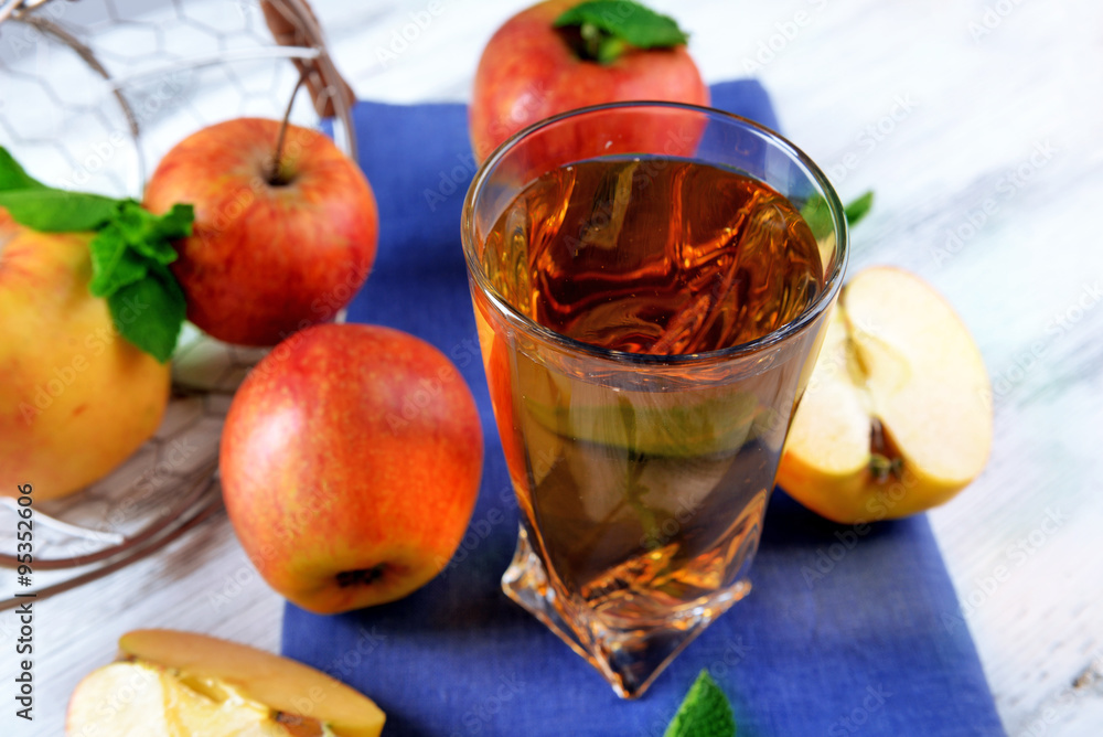 Glass of apple juice with fruits and fresh mint on table close up Glass of apple juice with fruits and fresh mint on table close up