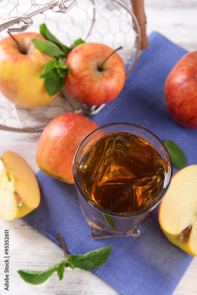 Glass of apple juice with fruits and fresh mint on table close up Glass of apple juice with fruits and fresh mint on table close up