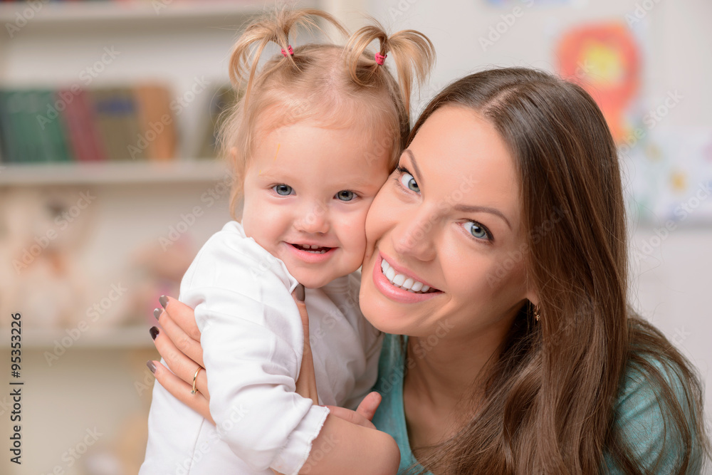 Attractive young woman is hugging her child Attractive young woman is hugging her child