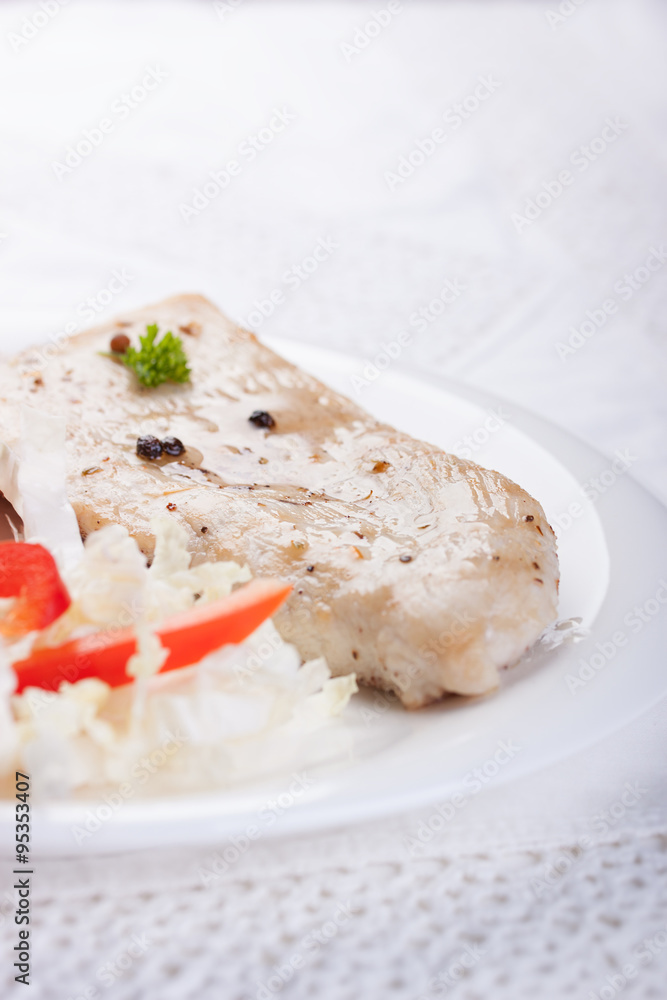 Roasted chicken filet with vegetables on a white plate.. Roasted chicken filet with vegetables on a white plate..