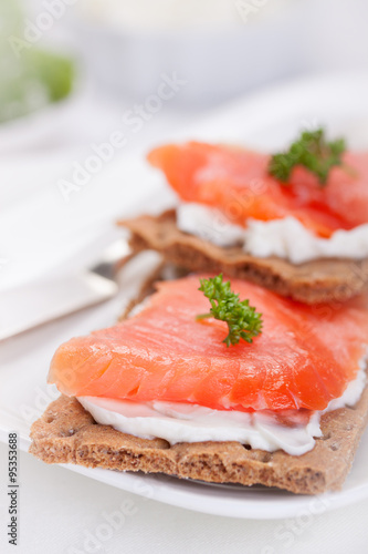 Sandwich with smoked salmon and cottage cheese on a white plate.