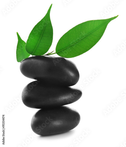Black spa stones and green flower  isolated on white