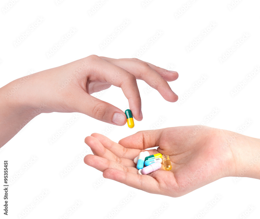 Drug capsules and pills in hand with drinking water Drug capsules and pills in hand with drinking water