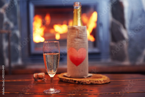 Bottle of wine on table  on fireplace background