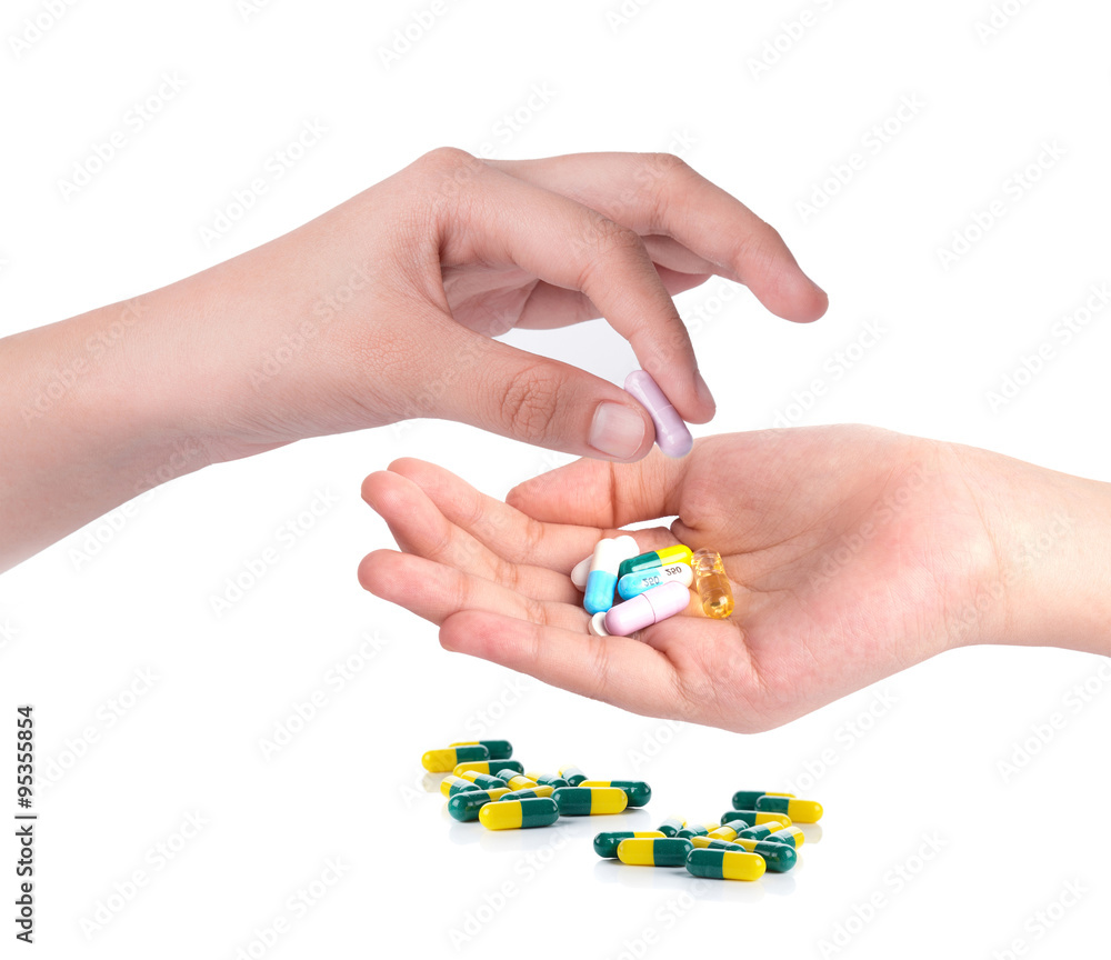 Drug capsules and pills in hand with drinking water Drug capsules and pills in hand with drinking water