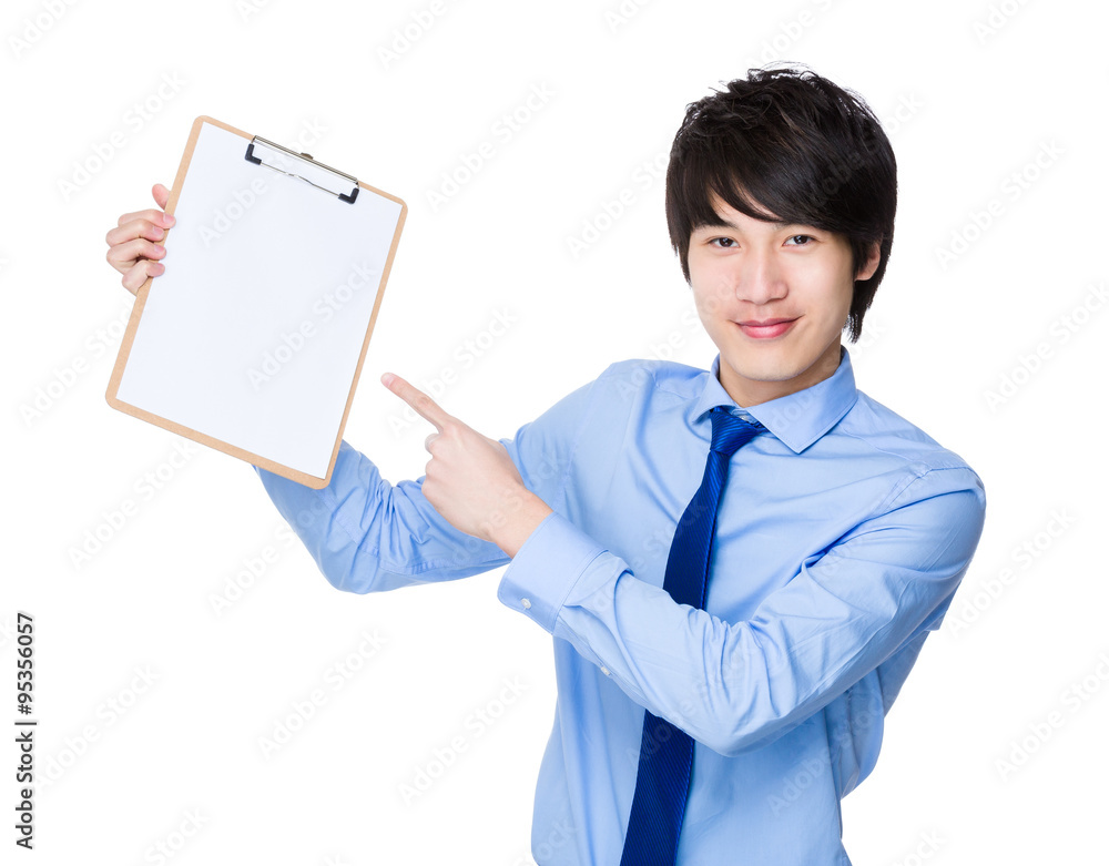 Asian Young Businessman finger point to the blank page of clipbo Asian Young Businessman finger point to the blank page of clipbo