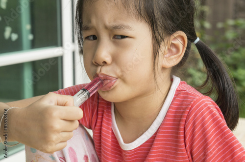 Asian child girl childhood medicine cold fever concept
