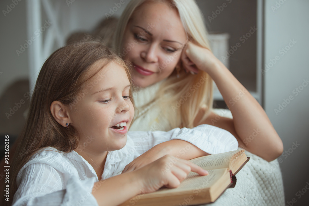 Mother with daughter reading book Mother with daughter reading book