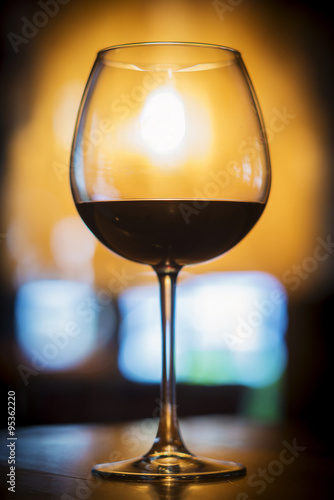 glass of red wine in cozy bar interior