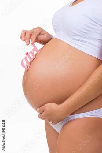 Wallpaper Mural Close-up of pregnant tummy with pink label "Girl" for newborn daughter on vertical white background Torontodigital.ca