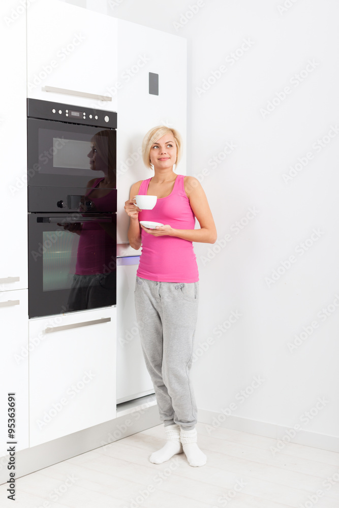young woman hold cup of coffee kitchen
