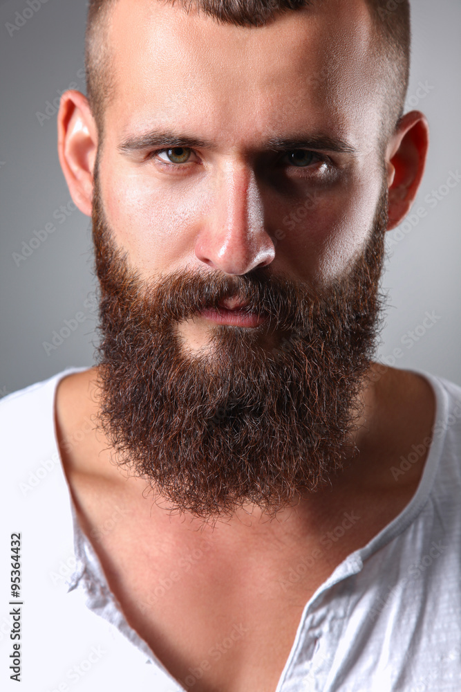 Fototapeta premium Portrait of handsome man standing, isolated on grey background