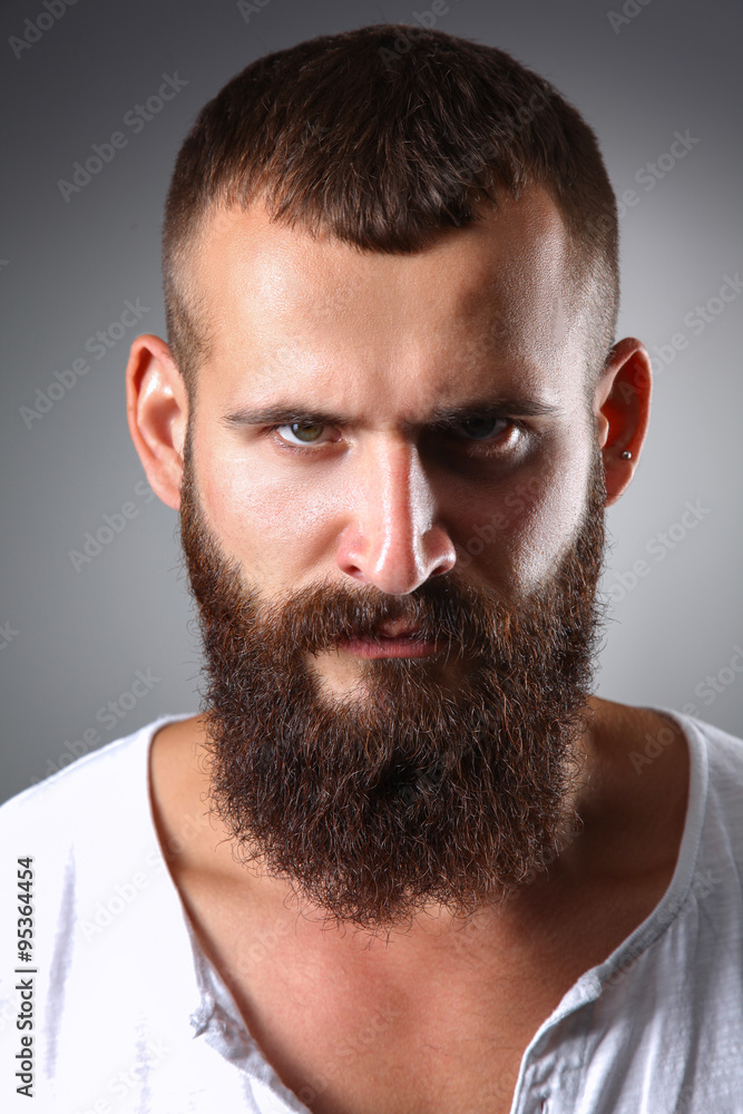Portrait of handsome man standing, isolated on grey background Portrait of handsome man standing, isolated on grey background