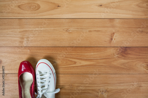 couple shoes over wooden deck floor.